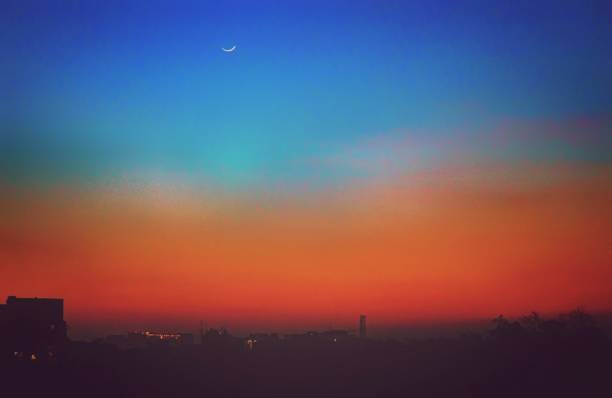 istock Bright moon in a Dark Beautiful Evening sky  - view from a city 954655964