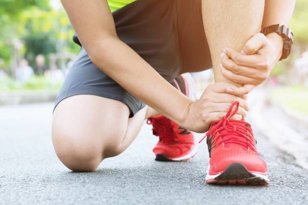 istock Runner touching painful twisted or broken ankle. Athlete runner training accident. Sport running ankle sprained sprain cause injury. 954656680