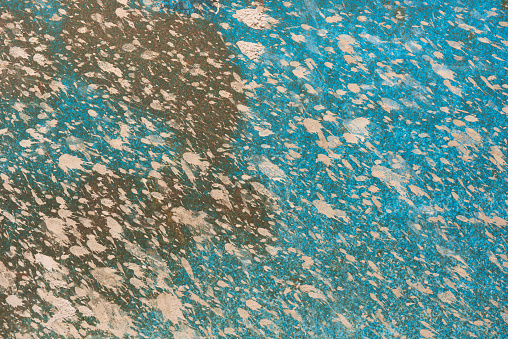 Dry mud on a blue metal plate.