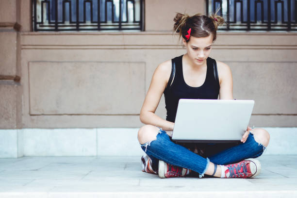 istock Young hipster girl with laptop outside. 954660998
