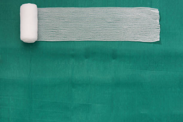 Roll gauze or thin bandage on medical tray on isolated white background for dressing or clean wound concept stock photo