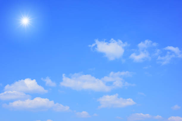istock Sun with sunlight in white clouds on blue sky. 954666658