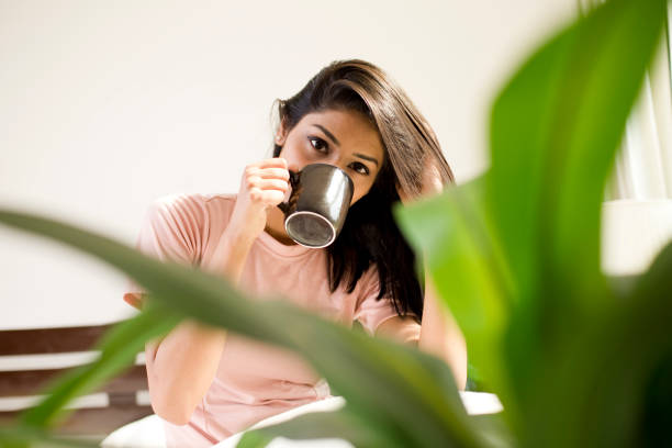 istock Beautiful woman drinking coffee 954669788