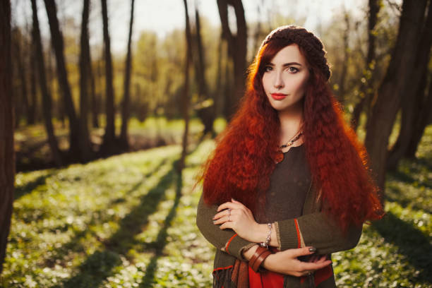 istock red haired girl in the forest 954672104