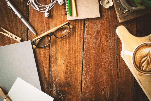 istock Hot coffee and stationery on the wood table. 954678020