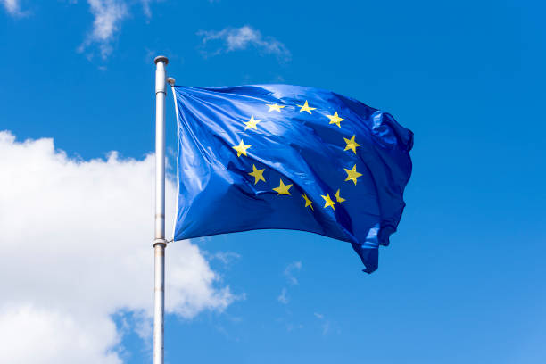 EU Flag waving against blue Sky EU Flag waving against blue Sky law european community european union flag global communications stock pictures, royalty-free photos & images