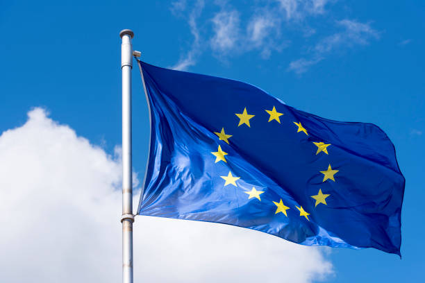 青空を振っている eu 旗 - european union flag european community europe flag ストックフォトと画像