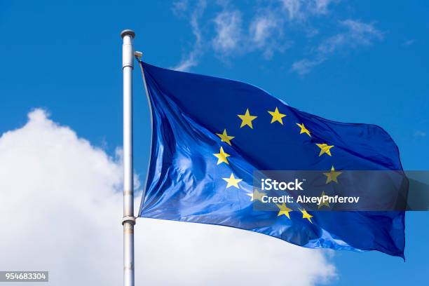 Eu Flag Waving Against Blue Sky Stock Photo - Download Image Now - European Union, Europe, European Union Flag