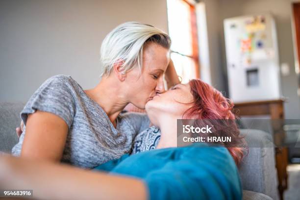 Passionate Lesbian Couple Kissing On Sofa At Home Stock Photo - Download Image Now - 30-34 Years, 35-39 Years, Adult - iStock