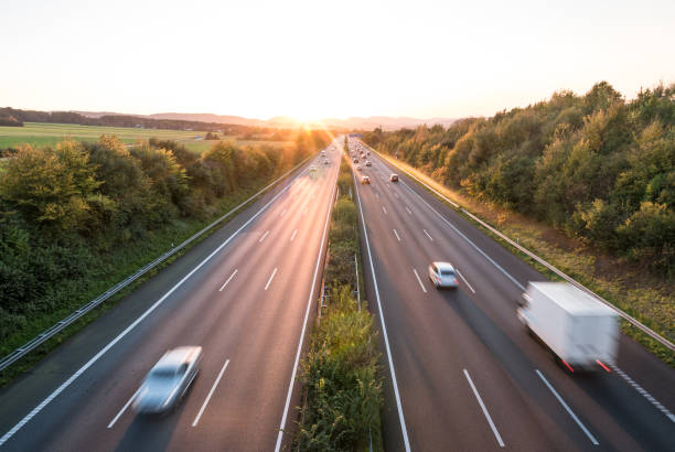 istock The road traffic on a motorway at sunset 954687004