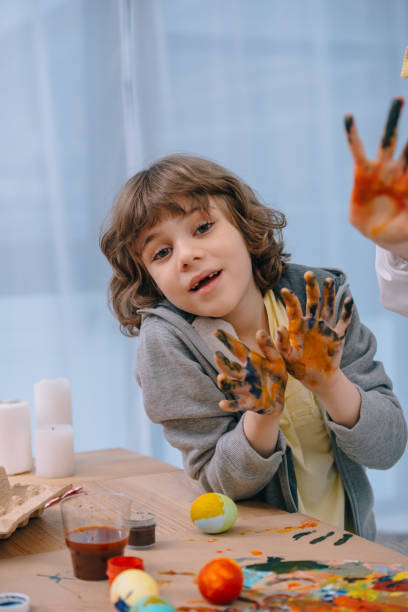 istock little kid showing his dirty colorful hands at camera 954689370