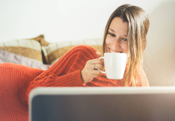istock Woman lies in bed and using laptop computer. 954694524