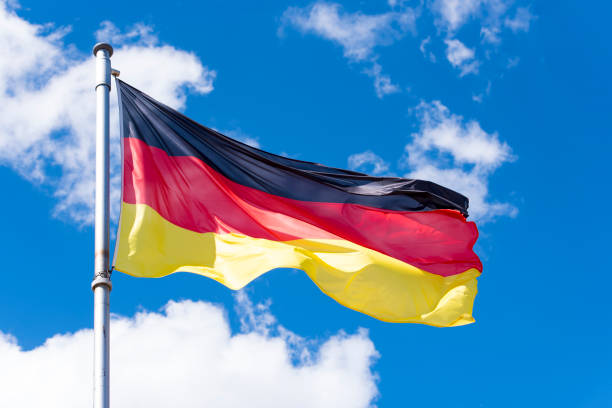 istock Flag of Germany against blue Sky in Berlin 954695422