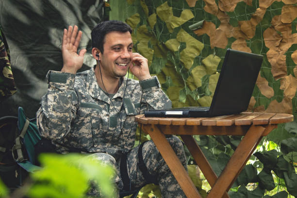 istock Army soldier video chatting with family 954700140