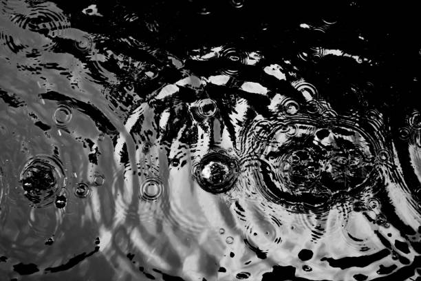istock Water ripples from a drop of water in the dark. 954701174