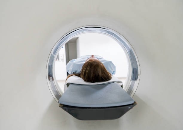 istock Unrecognizable female patient lying down ready for an MRI exam 954708060