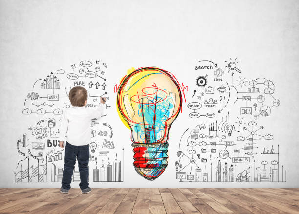 istock Cute little boy writing drawing marker idea 954708308