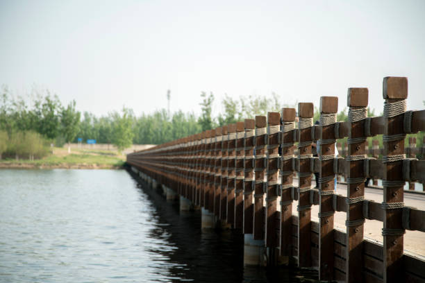 istock wooden railing of bridge over river 954708978