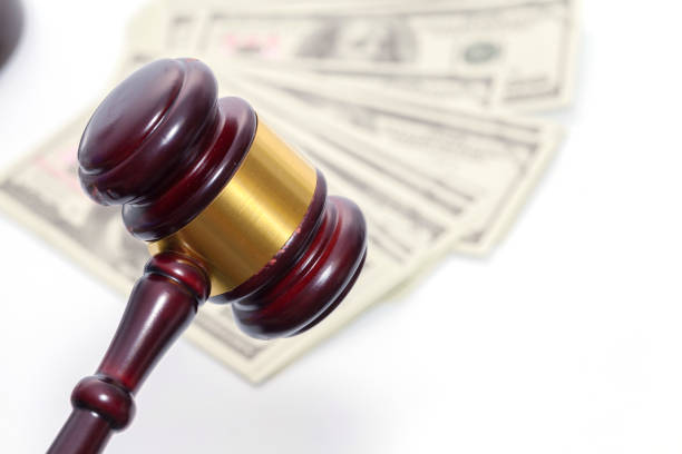 istock Judge Gavel with banknote on white background 954712578