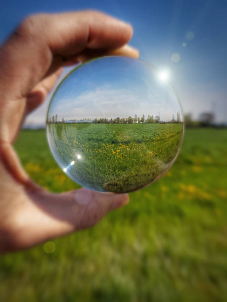 Playing with lens ball during the spring season Playing with lens ball crystal ball photos stock pictures, royalty-free photos & images