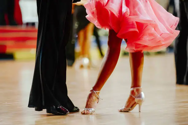 Photo of couple feet of dancers, woman and man latino dancing