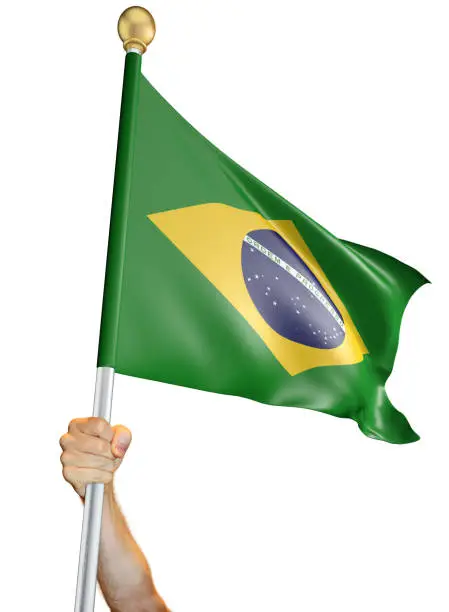 Man's hand holding a flag pole with the Brazilian national flag proudly displayed against a white background. The flag has been rendered with 3D software.