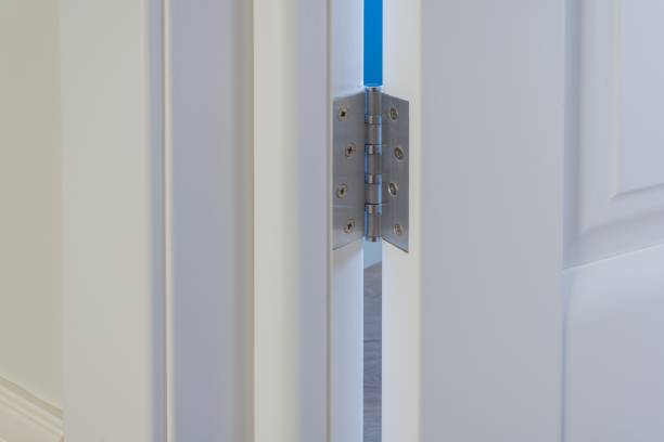 istock Metal chrome hinged hinges on white interior door 954712948