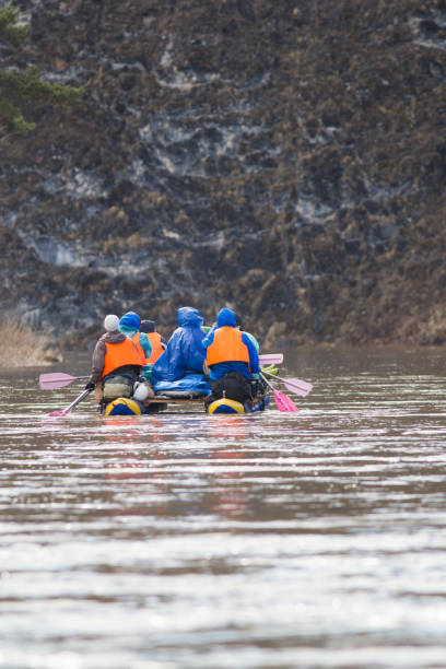 istock Group of people on the inflatable catamarans rafting on the river 954716094