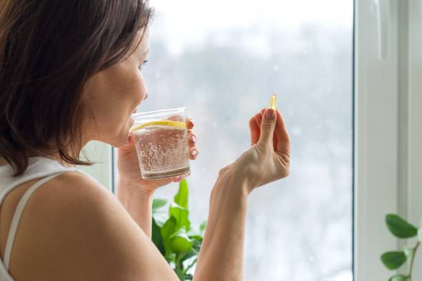 istock Woman takes pill with omega-3 954717854