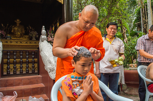 Chiang Rai, Thailand - April 1, 2018 : The Ordination Ceremony of the 2018 Ordination Program at Wat Phra Kaew Chiang Rai, hair shaving before ordination.