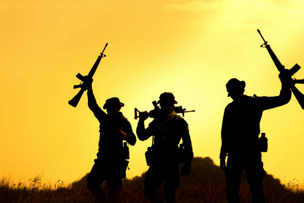istock Military soldier holding weapons overhead after get victory. 954721050
