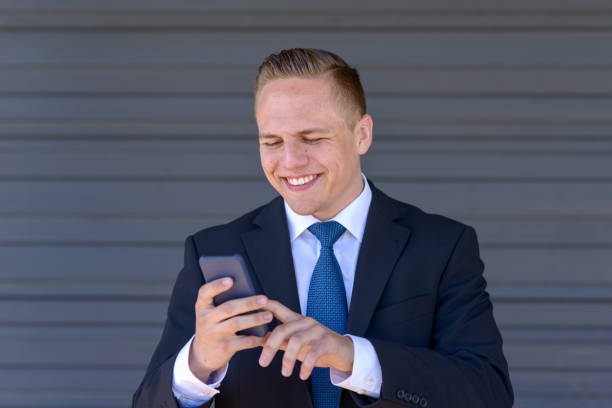 istock Young businessman texting on his mobile 954727756