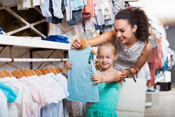 istock Mother with daughter buying clothes 954728494