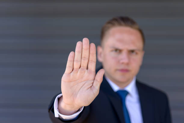 istock Young businessman giving a halt gesture 954731502