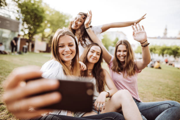 istock friends take a selfie in the park 954731988