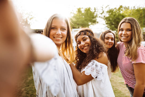 istock friends take a selfie in the park 954732042