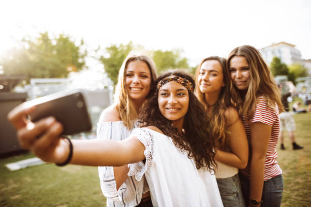 istock friends take a selfie in the park 954732094