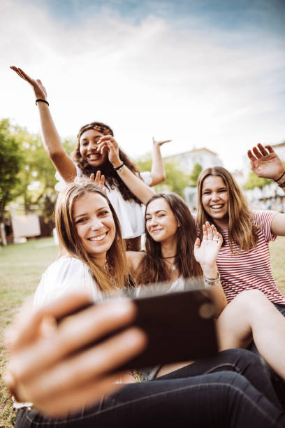 istock friends take a selfie in the park 954732120