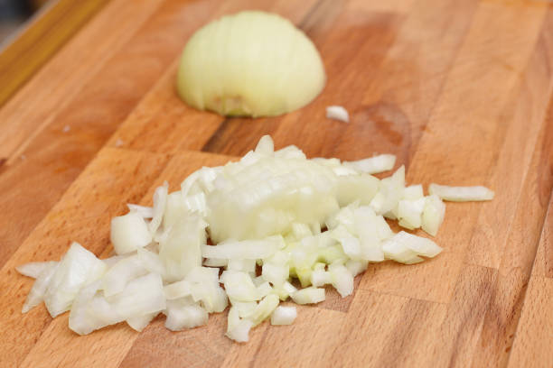 istock Finely chopped fresh onion on a cutting board in the kitchen 954732488