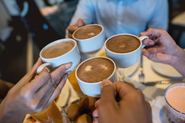 istock Unrecognizable people having breakfast at home toasting with hot chocolate 954735616