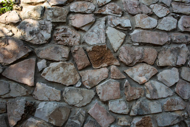istock Close up of natural stone wall. Stone wall texture 954736182