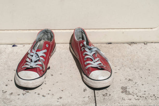 istock Grunge weathered red sneakers 954740154