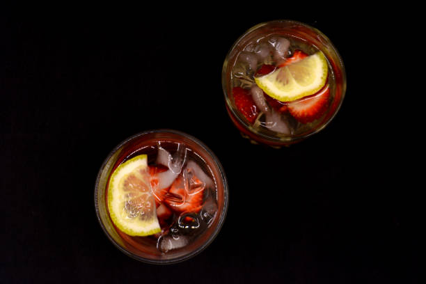 istock lemonade with strawberries on black background 954746140