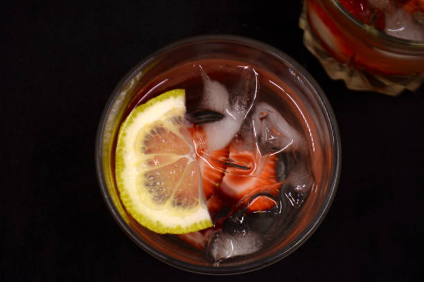 istock lemonade with strawberries on black background 954746144