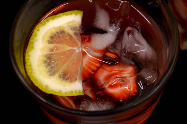 istock lemonade with strawberries on black background 954746150