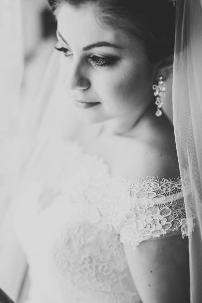 istock Luxury bride in white dress posing while preparing for the wedding ceremony 954747440