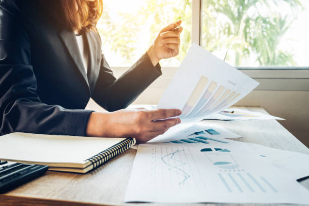 istock Business women reading document on office with tablet and graph financial diagram.Teamwork workplace strategy Concept. 954751418