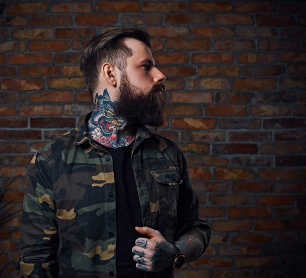 istock Tattooed bearded male in military jacket. 954751940