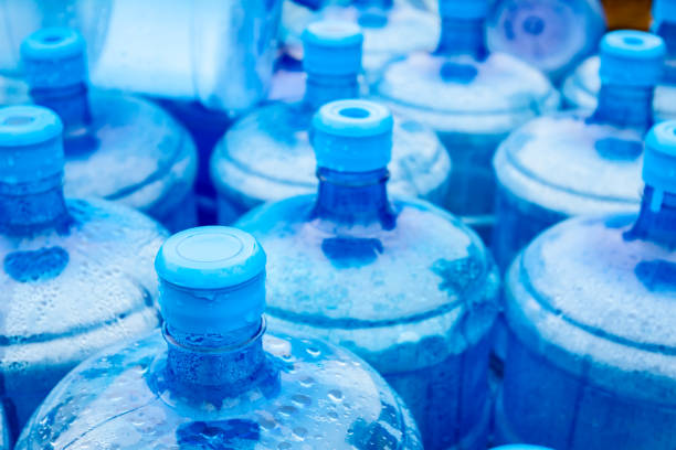 istock Big blue drinking water barrels, bottles, gallon, gets wet in the rain. 954752156