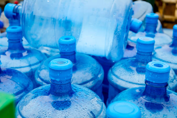 istock Big blue drinking water barrels, bottles, gallon, gets wet in the rain. 954752174